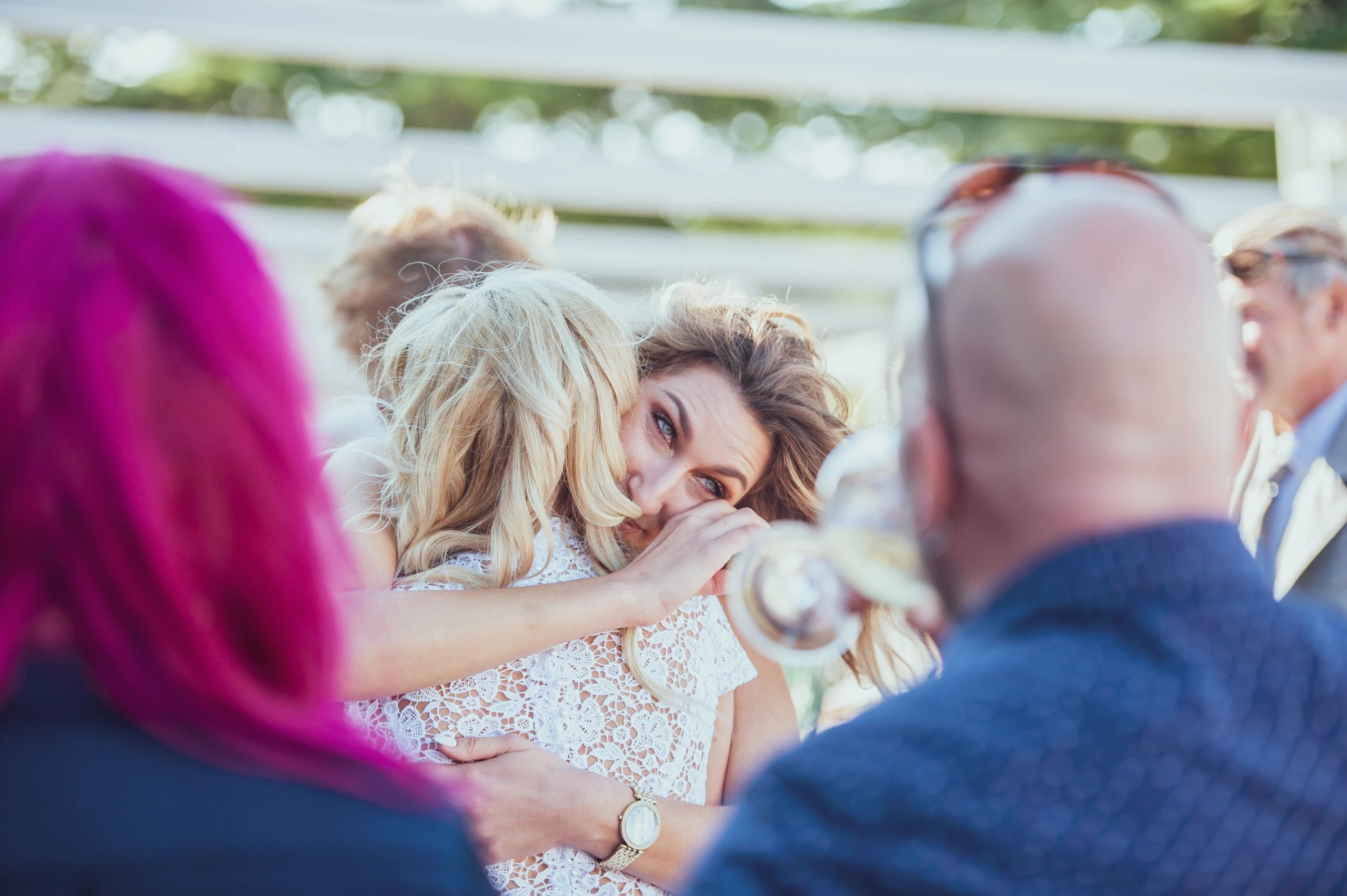 Bride being hugged by a guest during the celebration