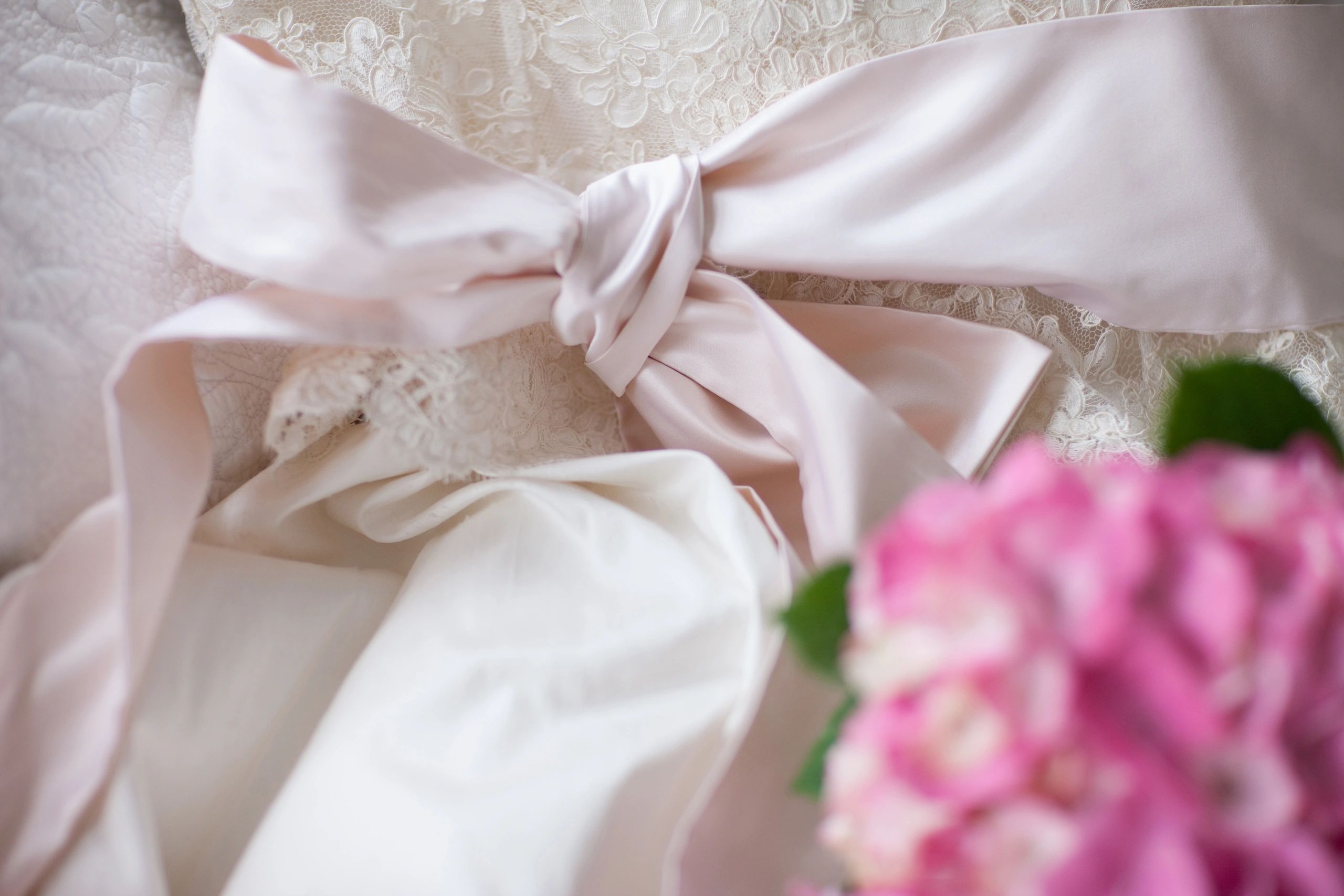Wedding bouquet resting on a bridal gown