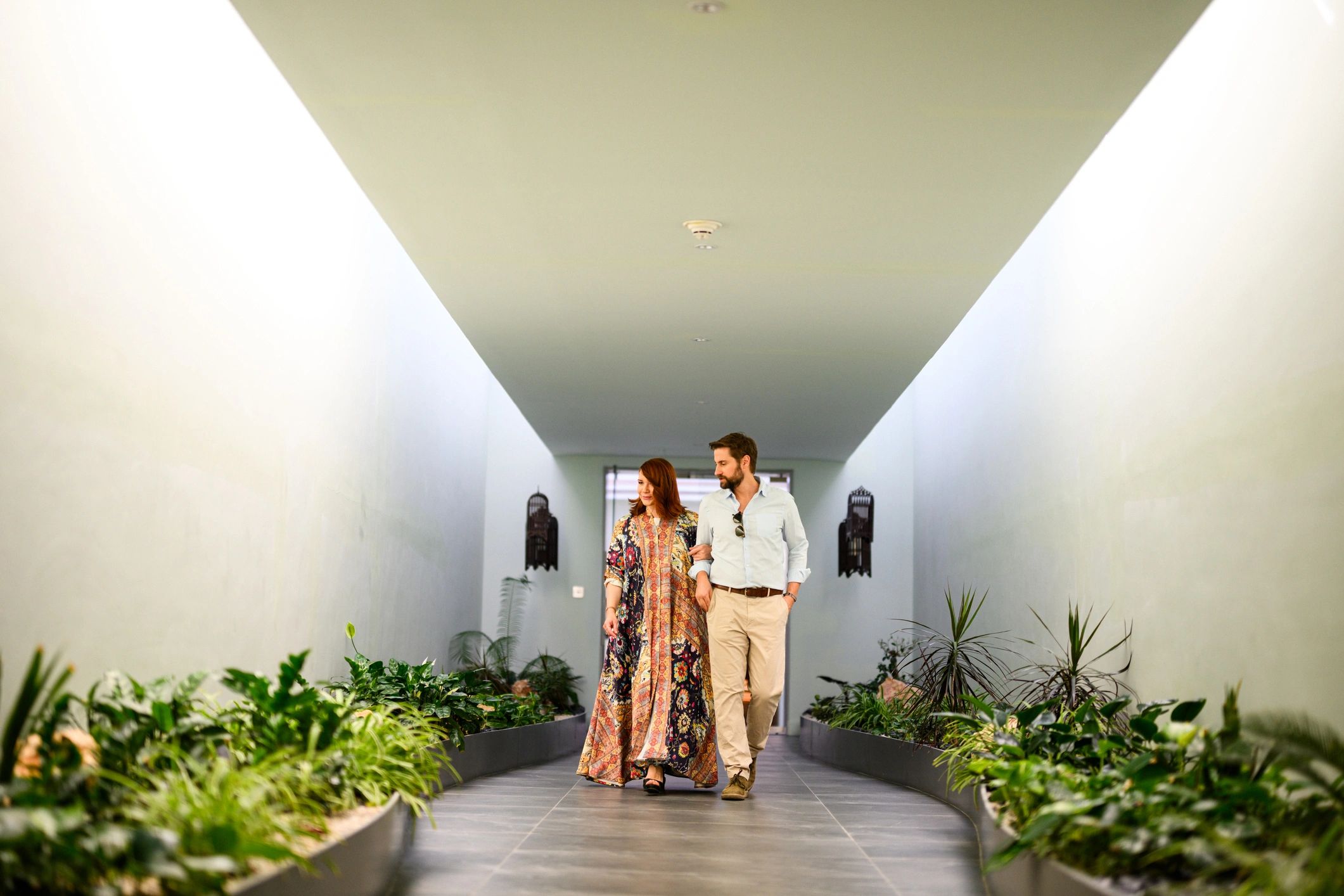 Couple walking through an elegant venue corridor
